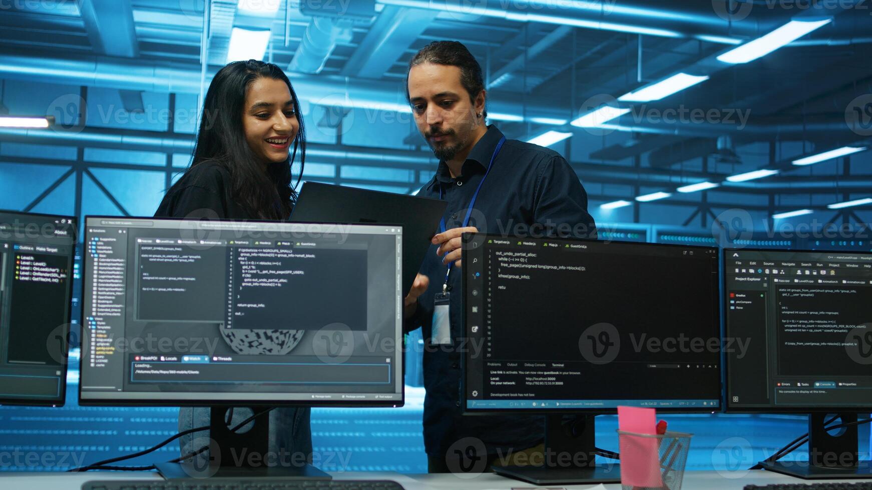 Engineers working in high tech server hub capable of processing and storing vast amounts of data. Specialists talking and troubleshooting server rows controlling network resources photo