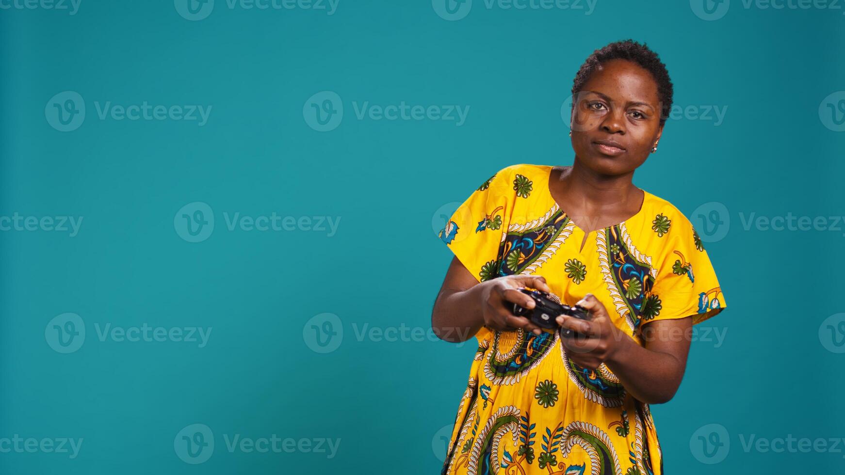 Displeased young woman feeling sad after losing at videogames, playing online with a controller and being frustrated with the lose. Disappointed person feels negative in studio. Camera B. photo