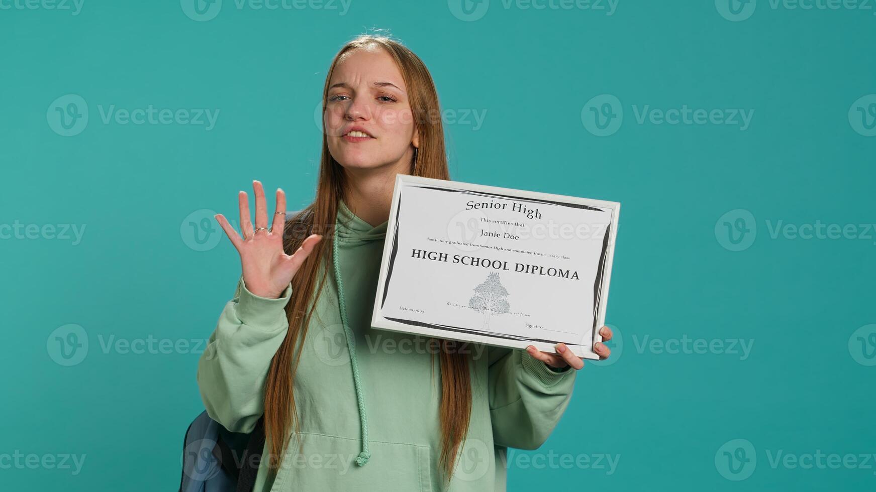 Cheerful teenager holding school award, excited after receiving accreditation for passing classes. Jolly person grateful for received honor, isolated over studio background, camera A photo
