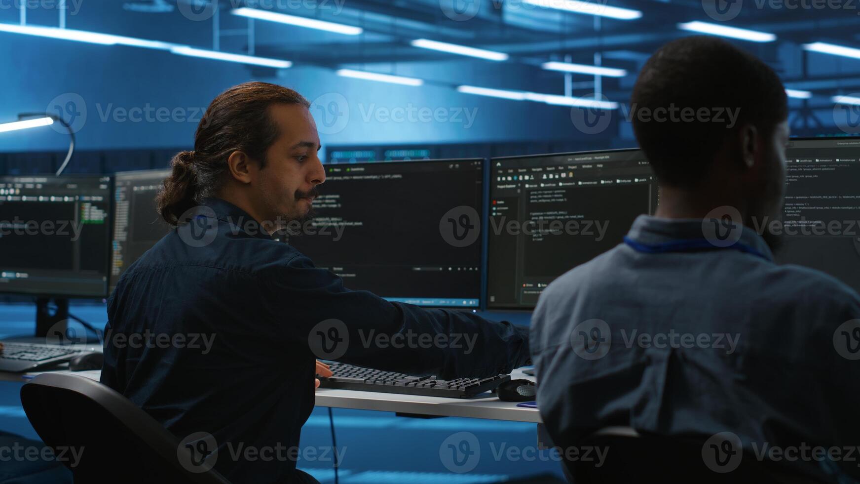 Manager overseeing server room and drinking coffee while running code on PC, troubleshooting hardware. System administrator programming in server farm on computer and enjoying hot beverage photo
