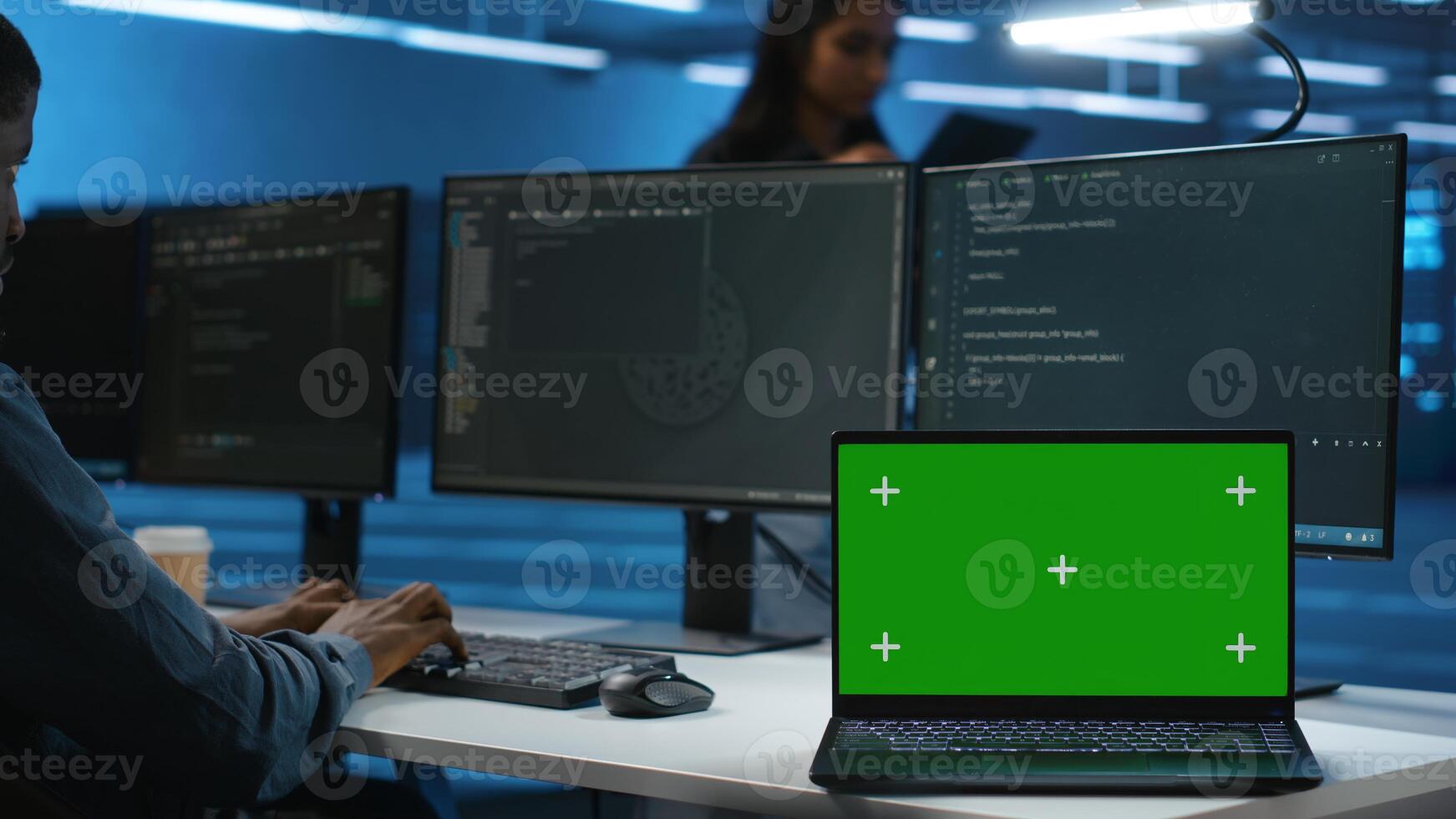 Expert in server hub workspace using isolated screen PC monitor to repair devices storing datasets. Technician using chroma key computer to do servicing on rigs doing computational operations photo