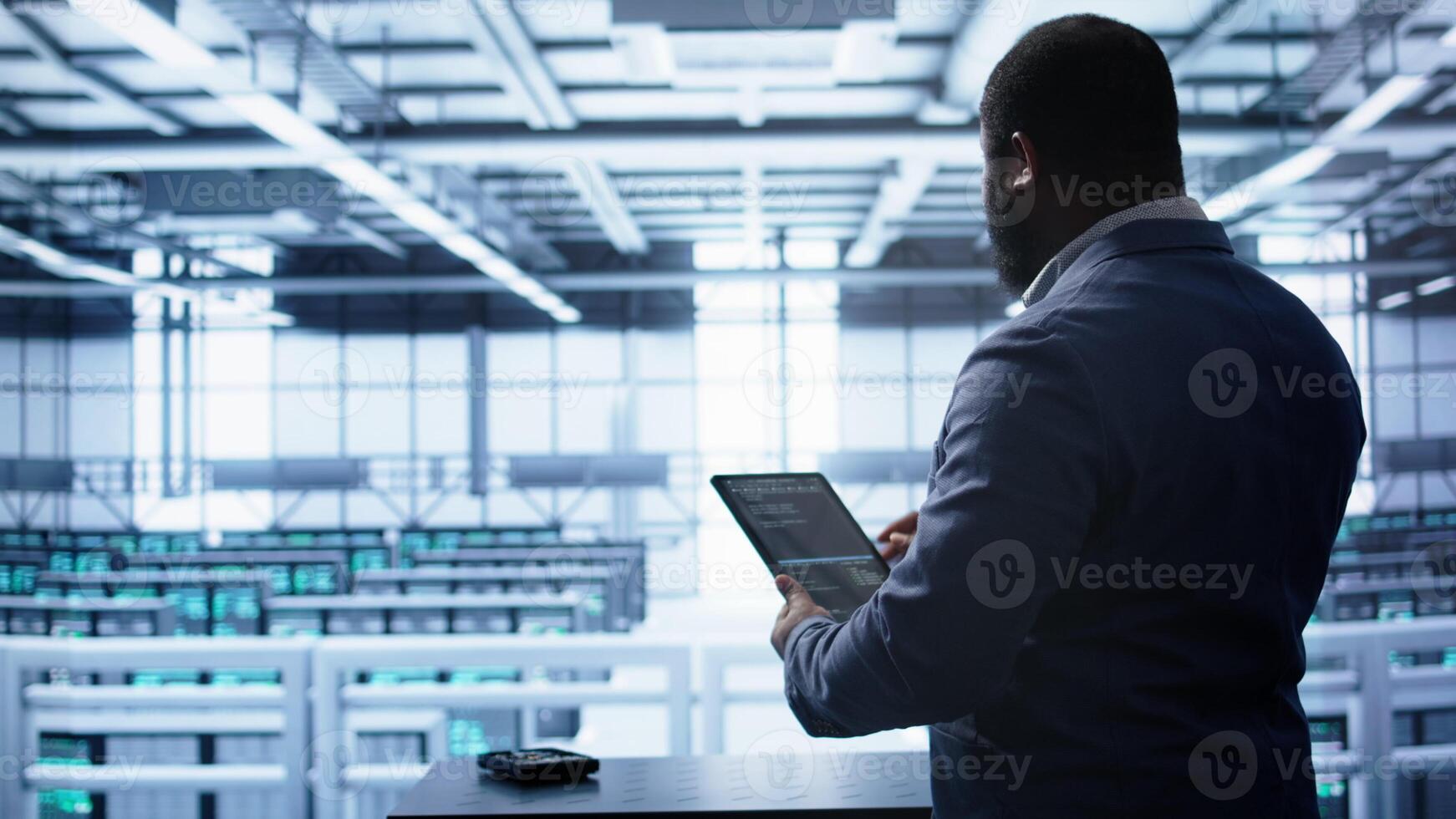 Technician in server hub workplace installing newly ordered storage unit, checking parameters with tablet. IT expert in data center holding device, replacing storage mainframes components, camera B photo