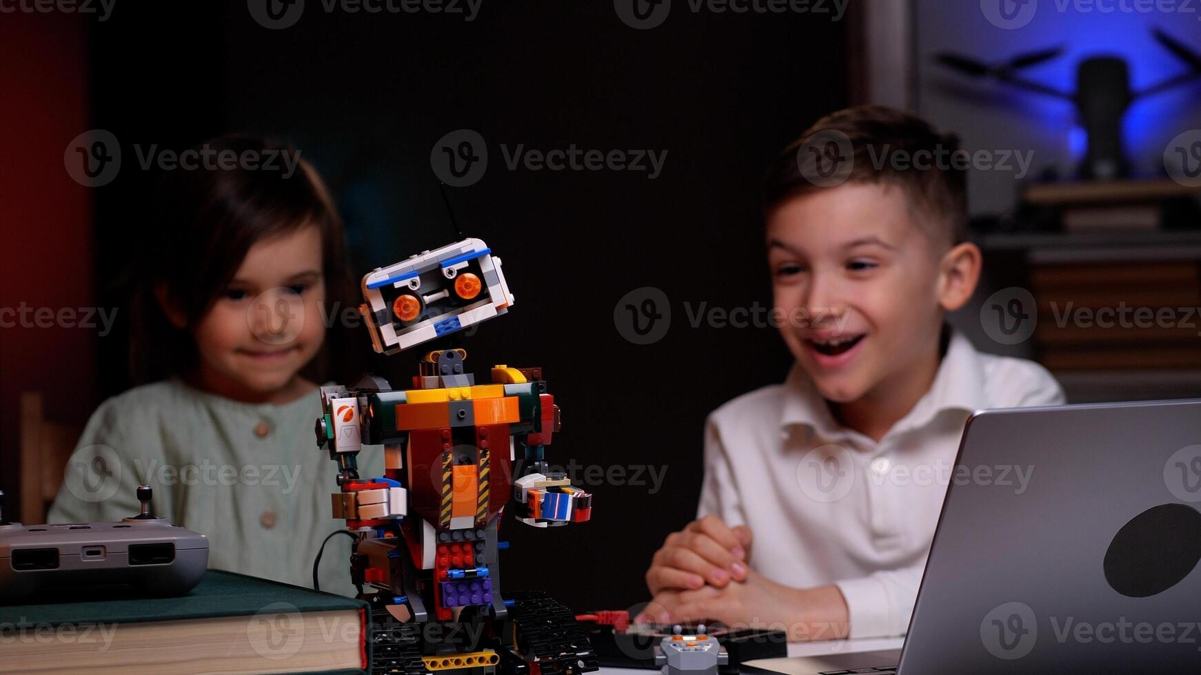 Happy children programming robot at home photo