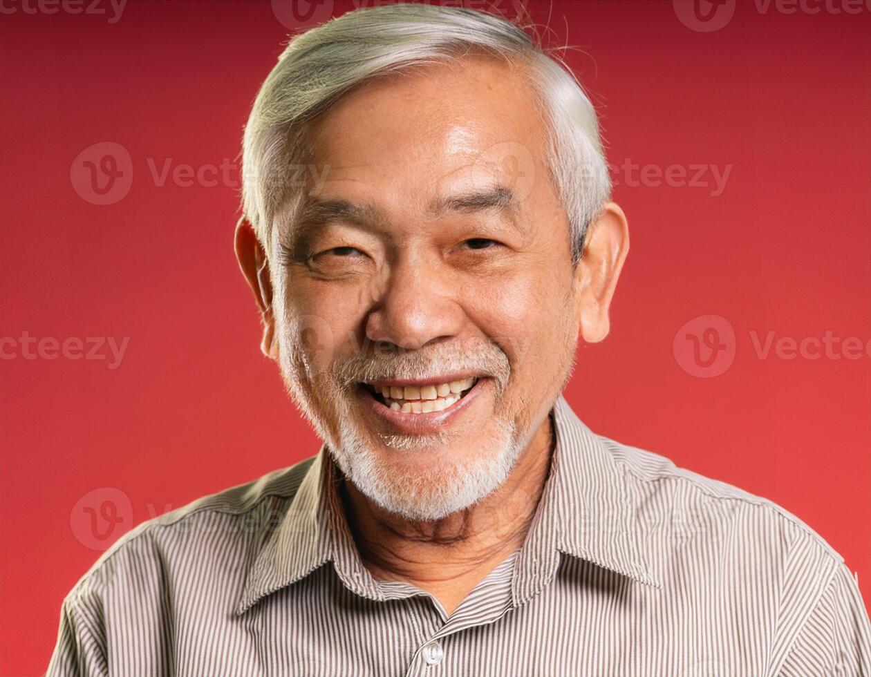 A men with 70 years old looking at the camera with excited facial expression in front of the red background photo