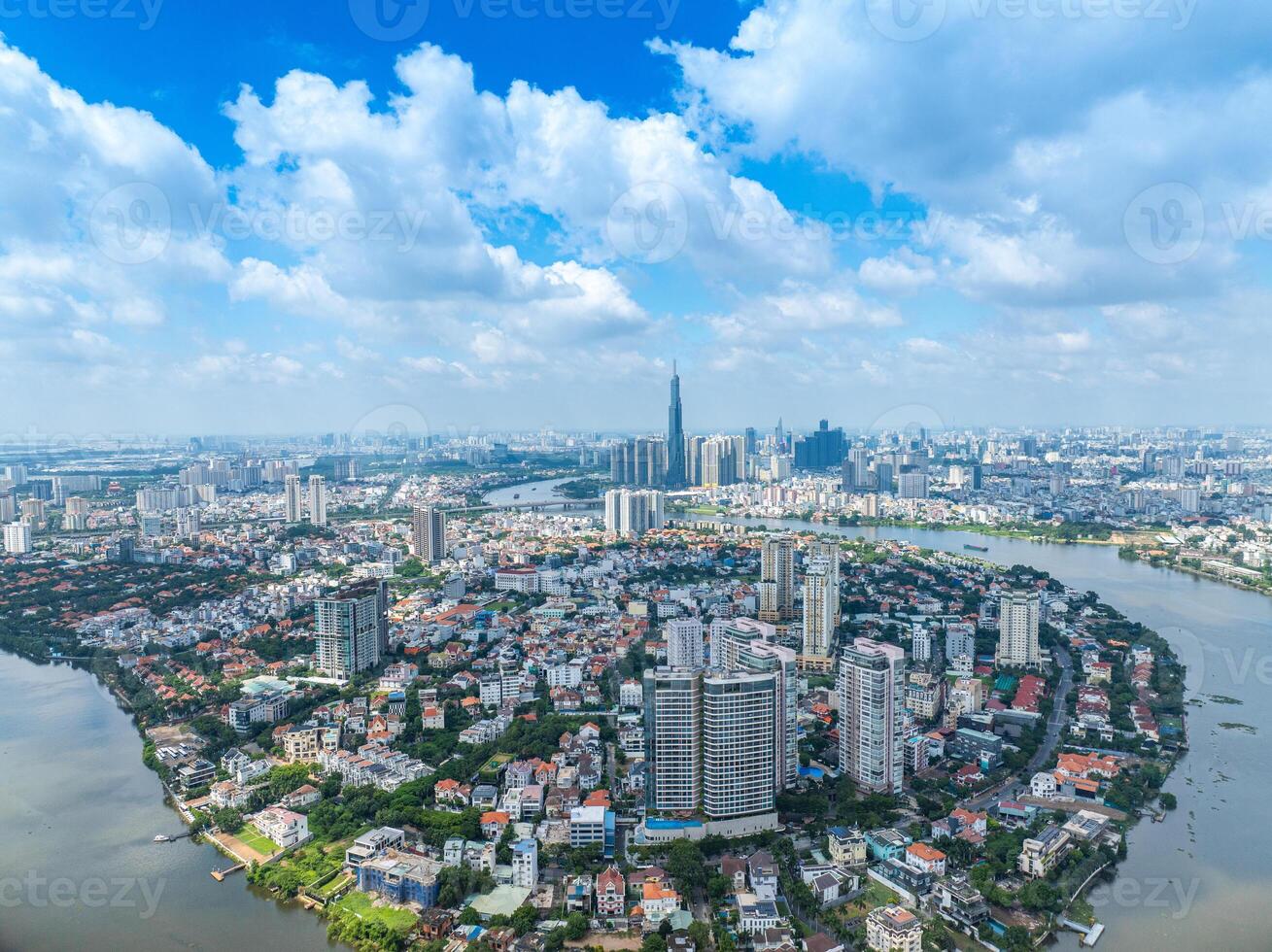 Panoramic view of Saigon, Vietnam from above at Ho Chi Minh City's central business district. Cityscape with Landmark 81 skyscraper and many buildings, local houses, rivers. photo