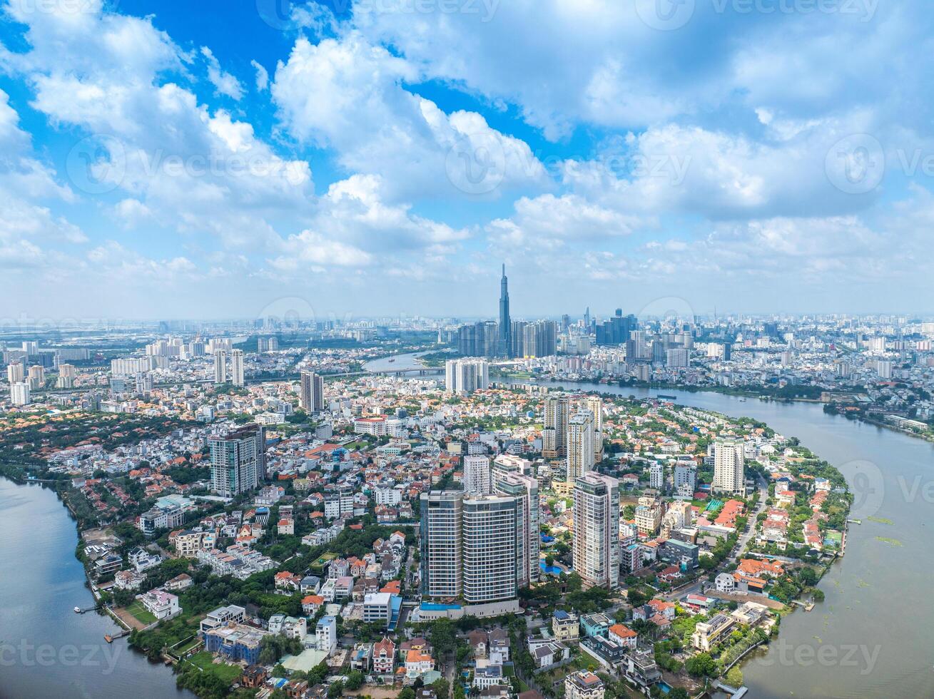 Panoramic view of Saigon, Vietnam from above at Ho Chi Minh City's central business district. Cityscape with Landmark 81 skyscraper and many buildings, local houses, rivers. photo