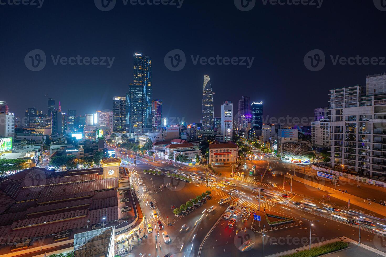 Night view of busy traffic in crowded intersection near Ben Thanh market in Ho Chi Minh city. Ben Thanh market is the symbol of Saigon, Vietnam photo