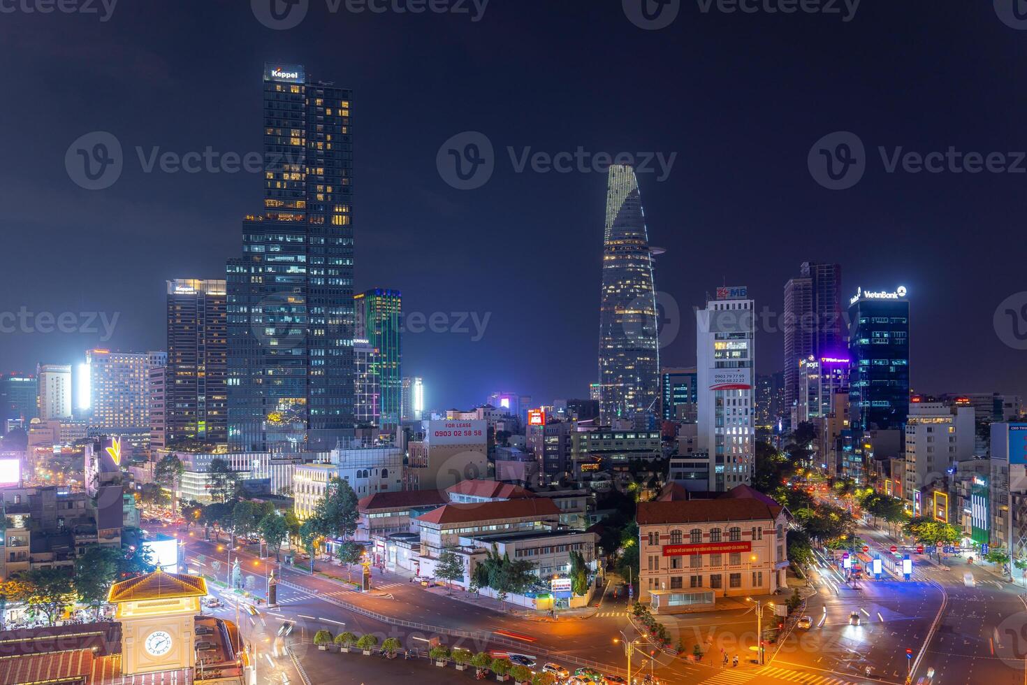 Night view of busy traffic in crowded intersection near Ben Thanh market in Ho Chi Minh city. Ben Thanh market is the symbol of Saigon, Vietnam photo