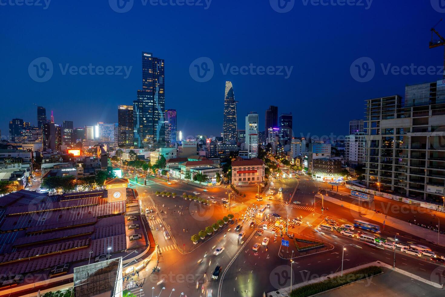 Night view of busy traffic in crowded intersection near Ben Thanh market in Ho Chi Minh city. Ben Thanh market is the symbol of Saigon, Vietnam photo