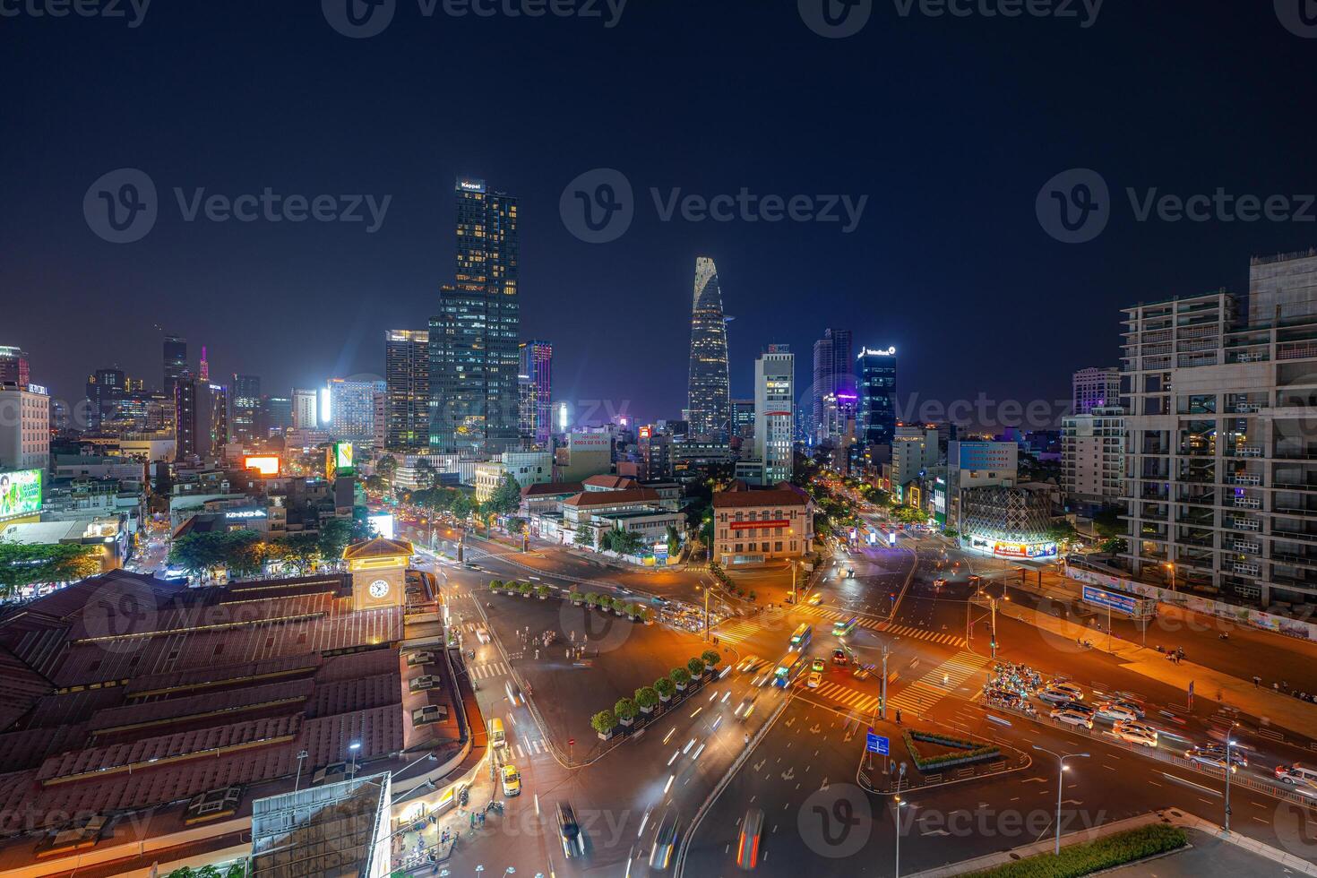Night view of busy traffic in crowded intersection near Ben Thanh market in Ho Chi Minh city. Ben Thanh market is the symbol of Saigon, Vietnam photo