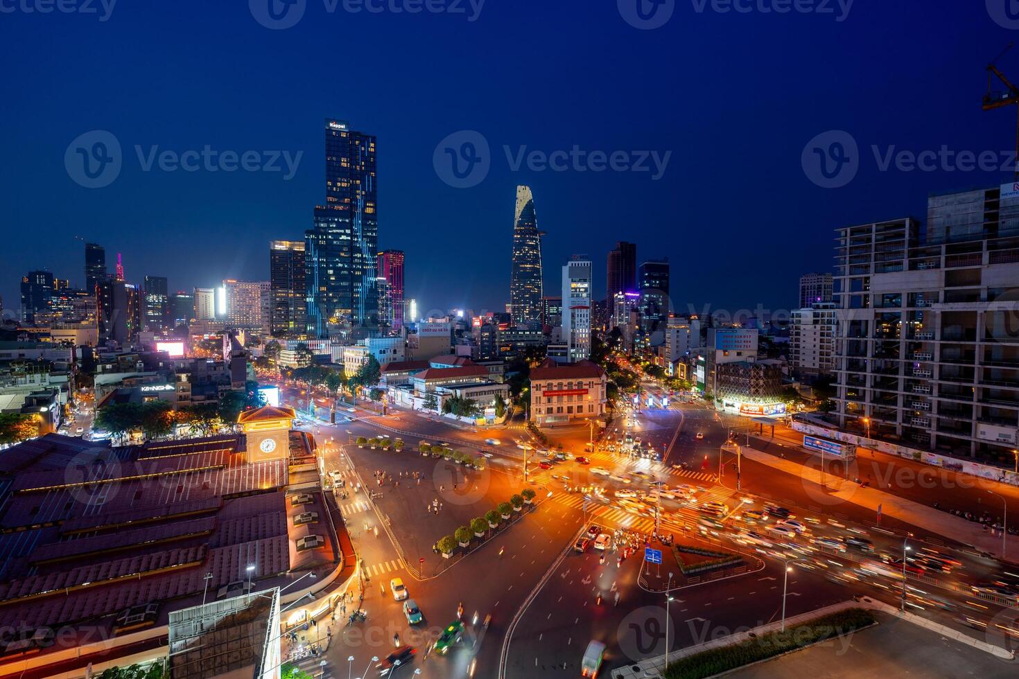 Night view of busy traffic in crowded intersection near Ben Thanh market in Ho Chi Minh city. Ben Thanh market is the symbol of Saigon, Vietnam photo