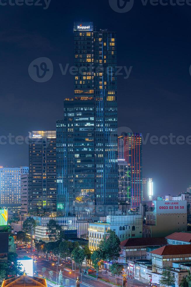 Night view of busy traffic in crowded intersection near Ben Thanh market in Ho Chi Minh city. Ben Thanh market is the symbol of Saigon, Vietnam photo