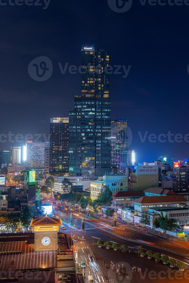 Night view of busy traffic in crowded intersection near Ben Thanh market in Ho Chi Minh city. Ben Thanh market is the symbol of Saigon, Vietnam photo