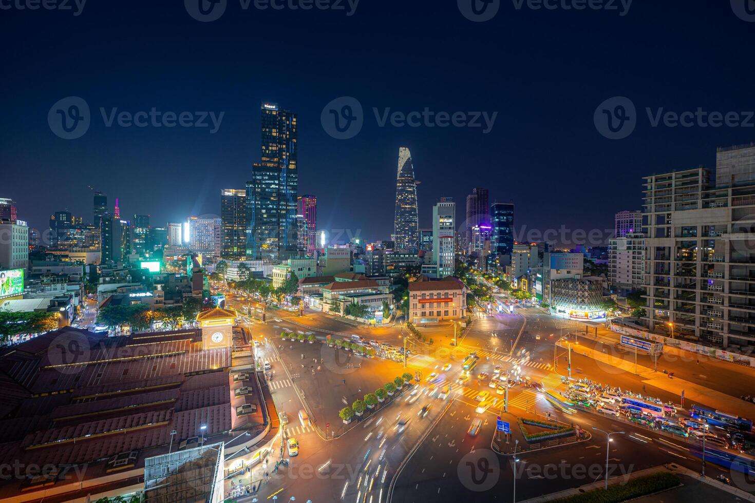 Night view of busy traffic in crowded intersection near Ben Thanh market in Ho Chi Minh city. Ben Thanh market is the symbol of Saigon, Vietnam photo