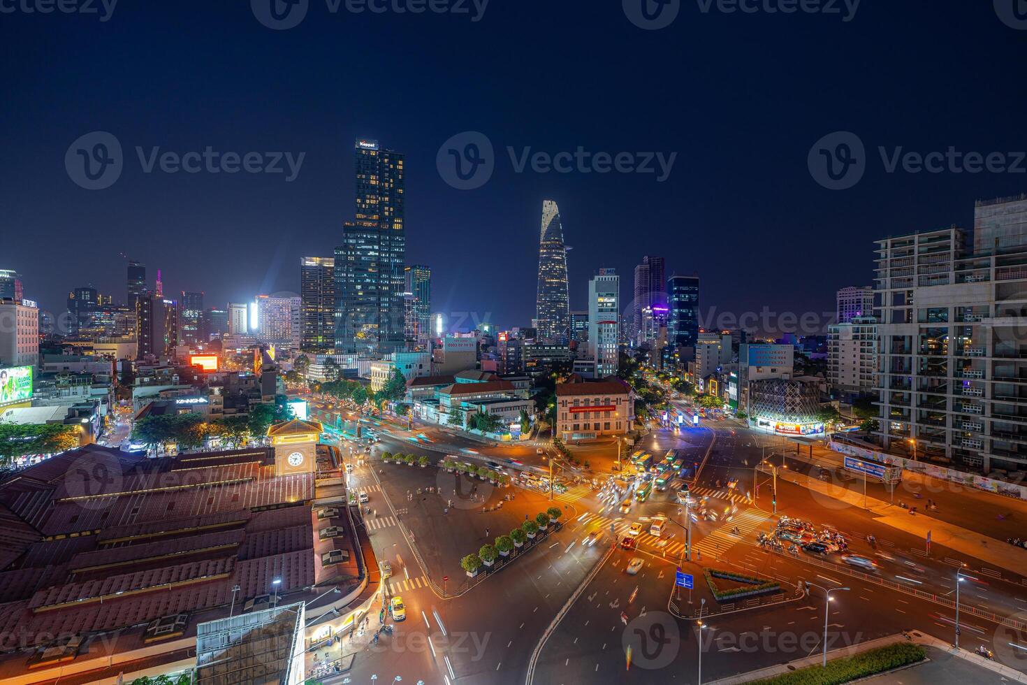 Night view of busy traffic in crowded intersection near Ben Thanh market in Ho Chi Minh city. Ben Thanh market is the symbol of Saigon, Vietnam photo