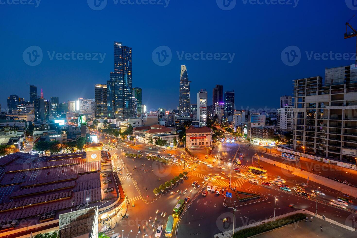Night view of busy traffic in crowded intersection near Ben Thanh market in Ho Chi Minh city. Ben Thanh market is the symbol of Saigon, Vietnam photo