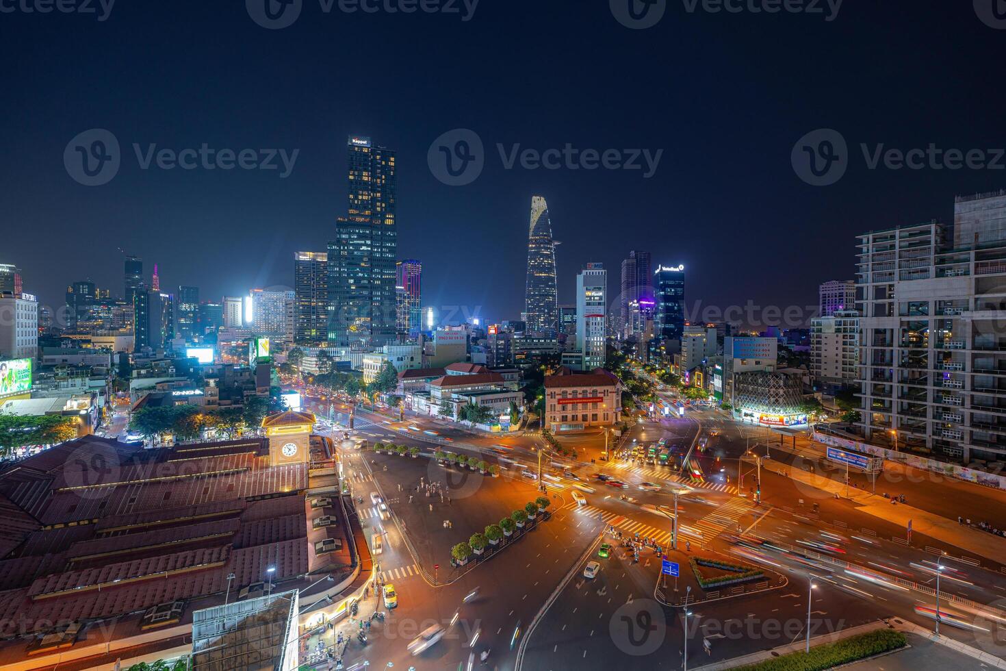 Night view of busy traffic in crowded intersection near Ben Thanh market in Ho Chi Minh city. Ben Thanh market is the symbol of Saigon, Vietnam photo