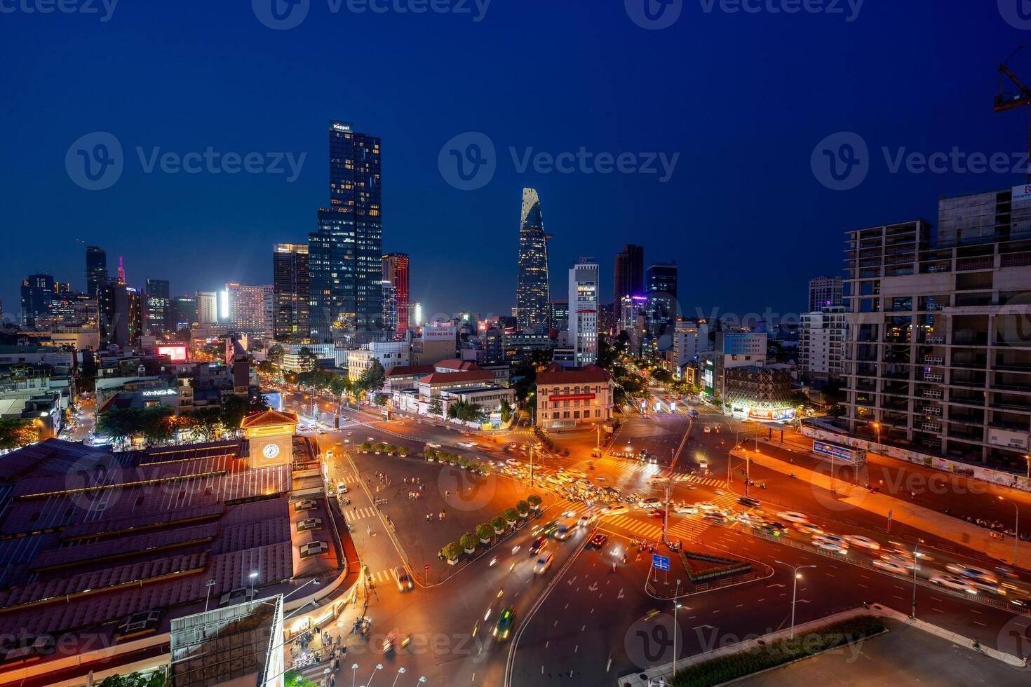 Night view of busy traffic in crowded intersection near Ben Thanh market in Ho Chi Minh city. Ben Thanh market is the symbol of Saigon, Vietnam photo