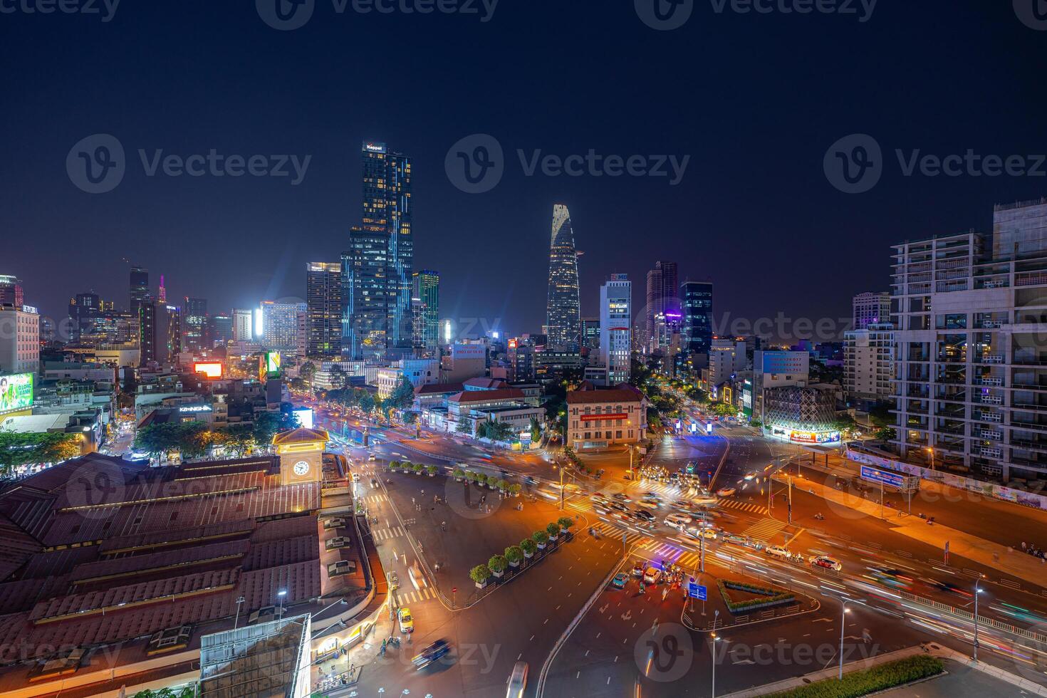Night view of busy traffic in crowded intersection near Ben Thanh market in Ho Chi Minh city. Ben Thanh market is the symbol of Saigon, Vietnam photo