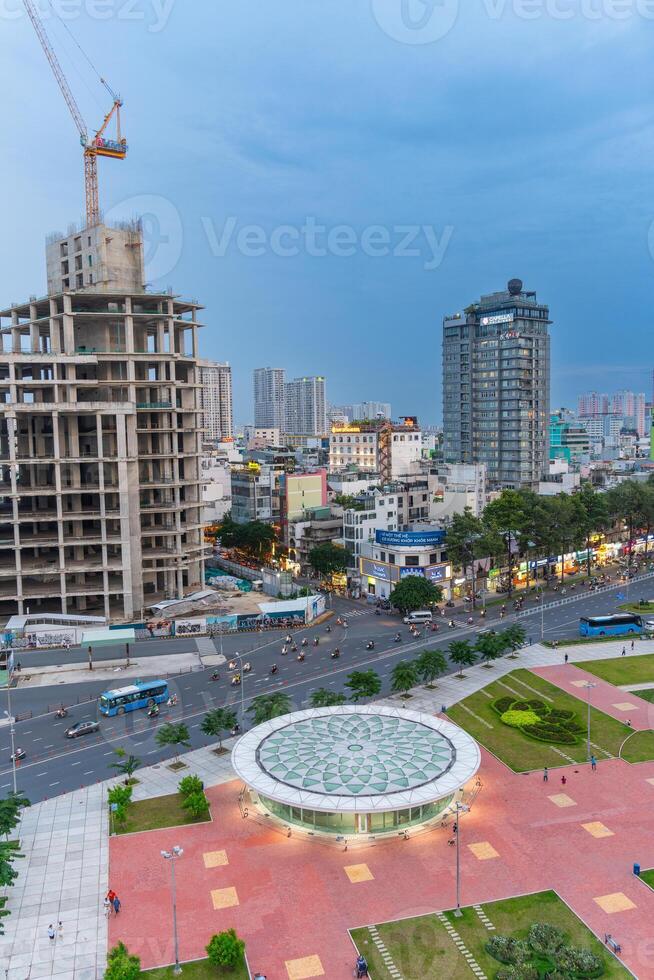 Night view of busy traffic in crowded intersection near Ben Thanh market in Ho Chi Minh city. Ben Thanh market is the symbol of Saigon, Vietnam photo