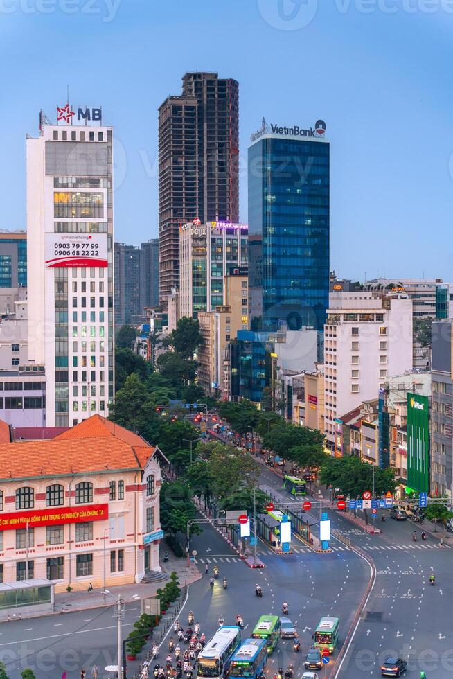 Night view of busy traffic in crowded intersection near Ben Thanh market in Ho Chi Minh city. Ben Thanh market is the symbol of Saigon, Vietnam photo
