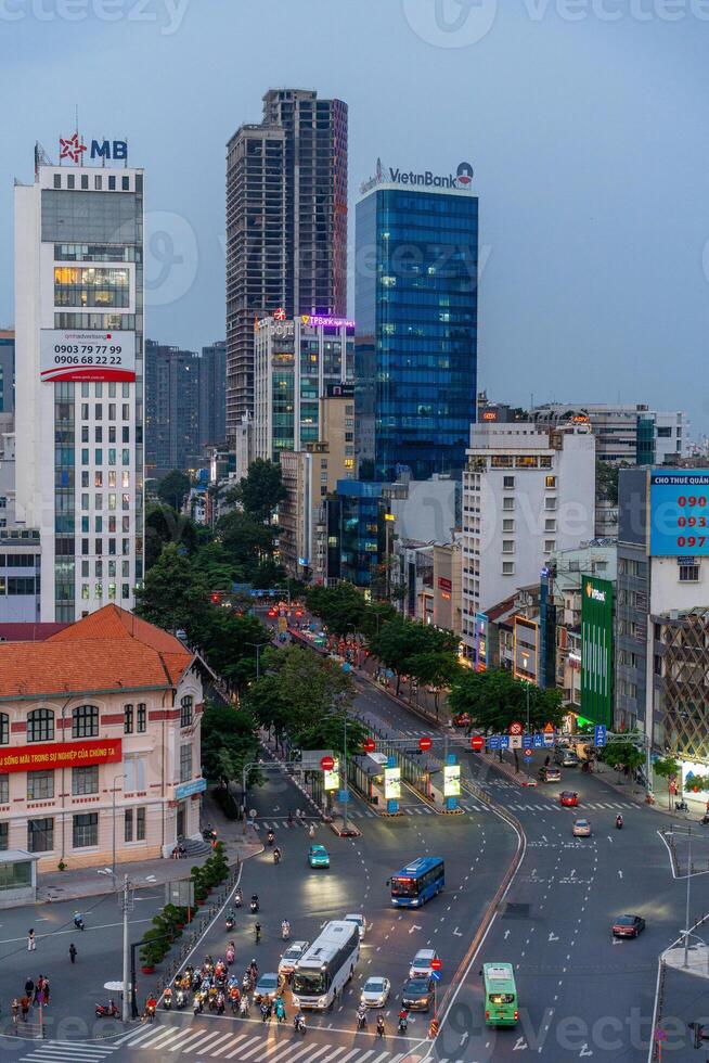 Night view of busy traffic in crowded intersection near Ben Thanh market in Ho Chi Minh city. Ben Thanh market is the symbol of Saigon, Vietnam photo
