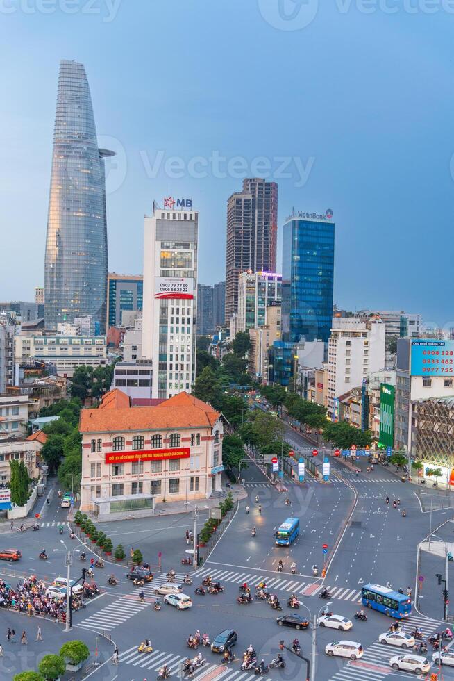 Night view of busy traffic in crowded intersection near Ben Thanh market in Ho Chi Minh city. Ben Thanh market is the symbol of Saigon, Vietnam photo