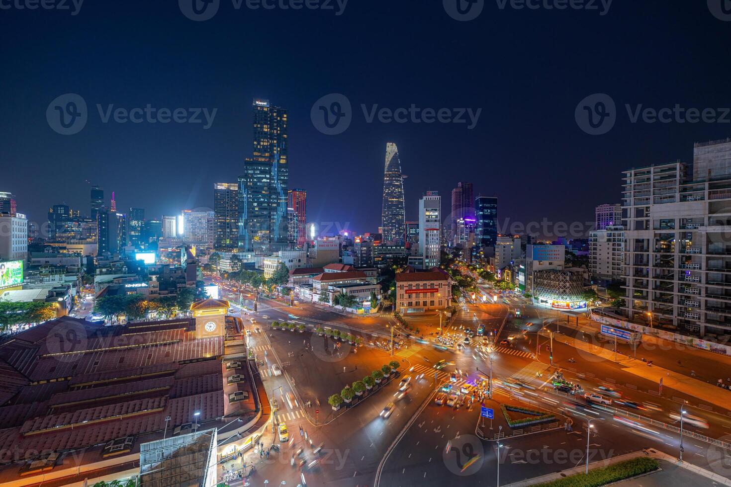 Night view of busy traffic in crowded intersection near Ben Thanh market in Ho Chi Minh city. Ben Thanh market is the symbol of Saigon, Vietnam photo