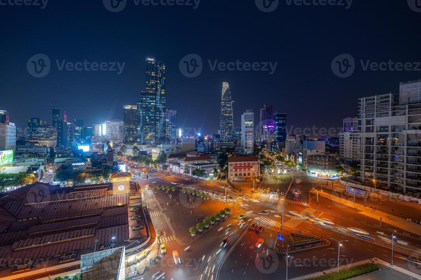 Night view of busy traffic in crowded intersection near Ben Thanh market in Ho Chi Minh city. Ben Thanh market is the symbol of Saigon, Vietnam photo