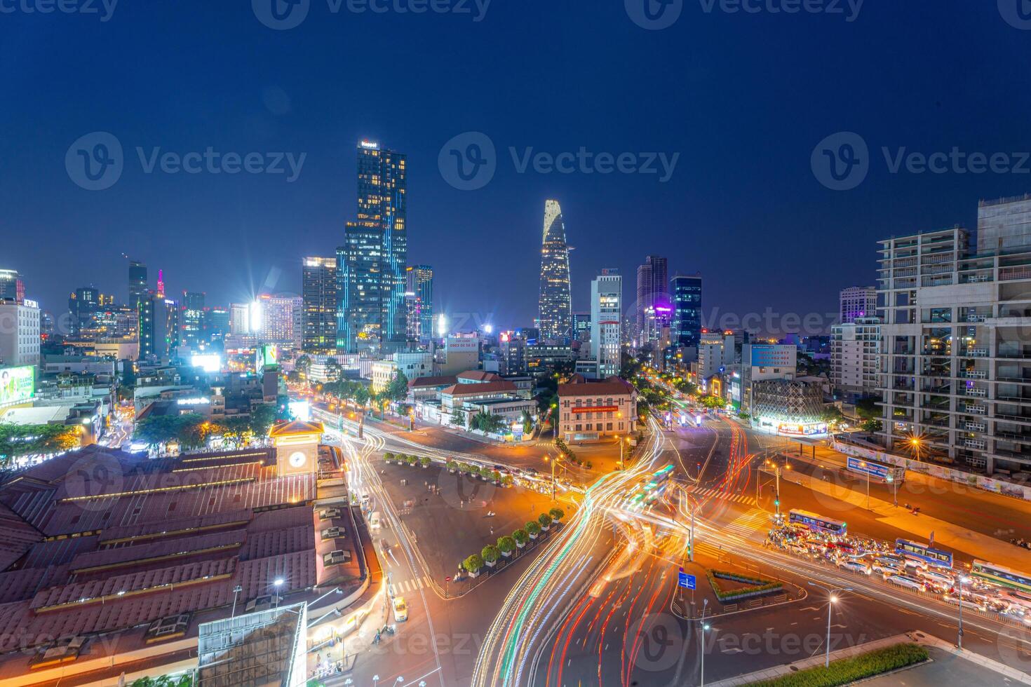 Night view of busy traffic in crowded intersection near Ben Thanh market in Ho Chi Minh city. Ben Thanh market is the symbol of Saigon, Vietnam photo