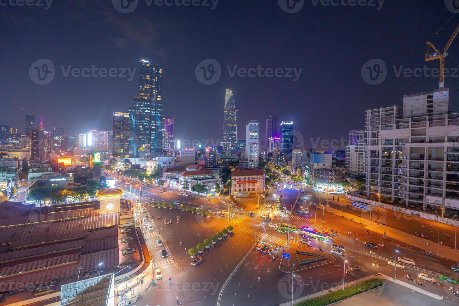 Night view of busy traffic in crowded intersection near Ben Thanh market in Ho Chi Minh city. Ben Thanh market is the symbol of Saigon, Vietnam photo