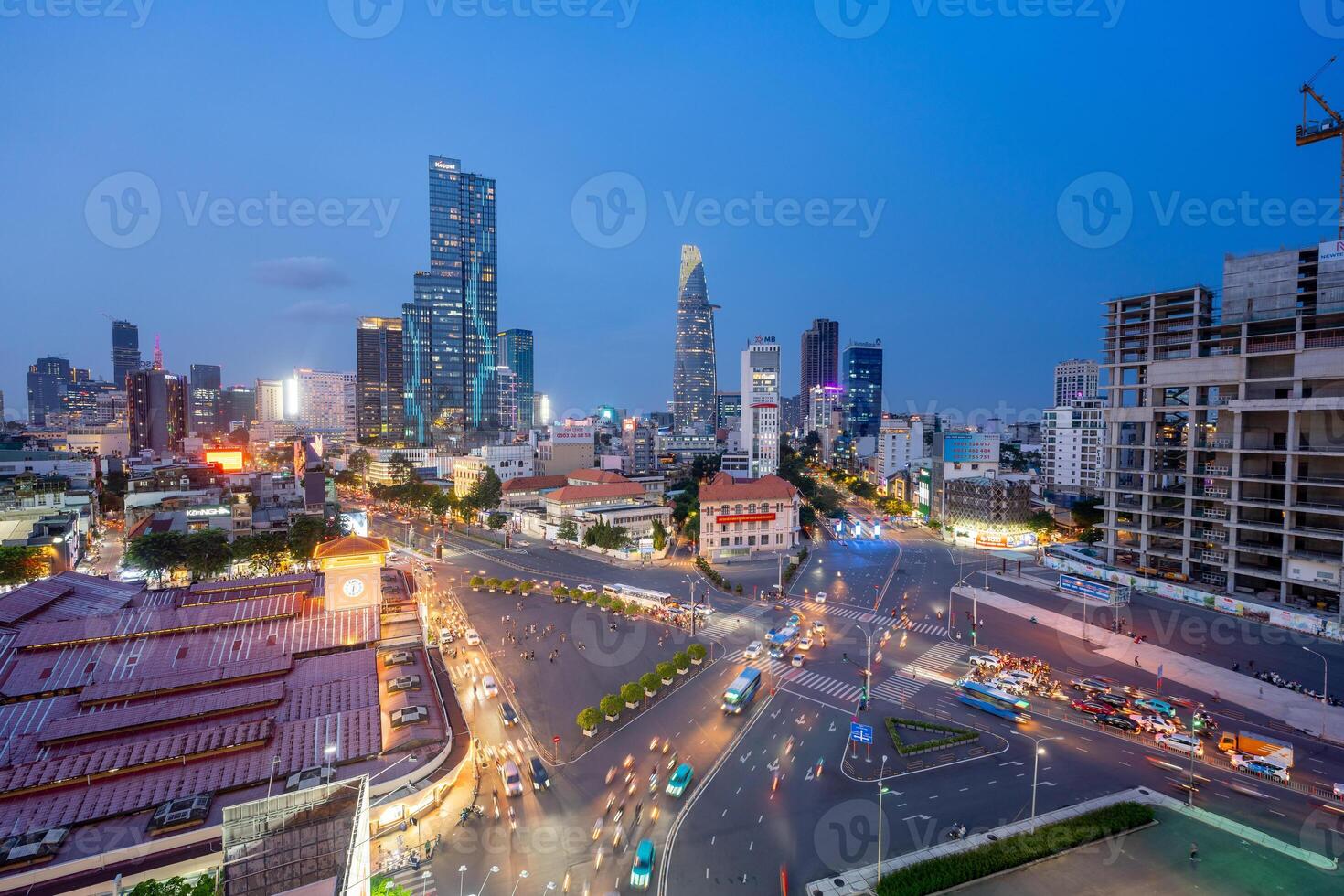 Night view of busy traffic in crowded intersection near Ben Thanh market in Ho Chi Minh city. Ben Thanh market is the symbol of Saigon, Vietnam photo