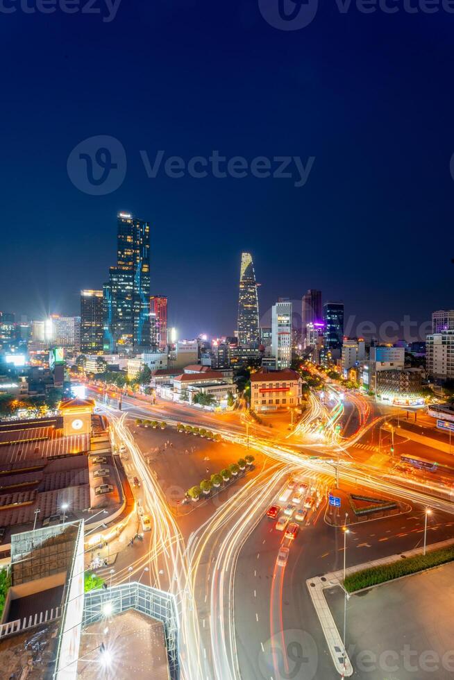 Night view of busy traffic in crowded intersection near Ben Thanh market in Ho Chi Minh city. Ben Thanh market is the symbol of Saigon, Vietnam photo