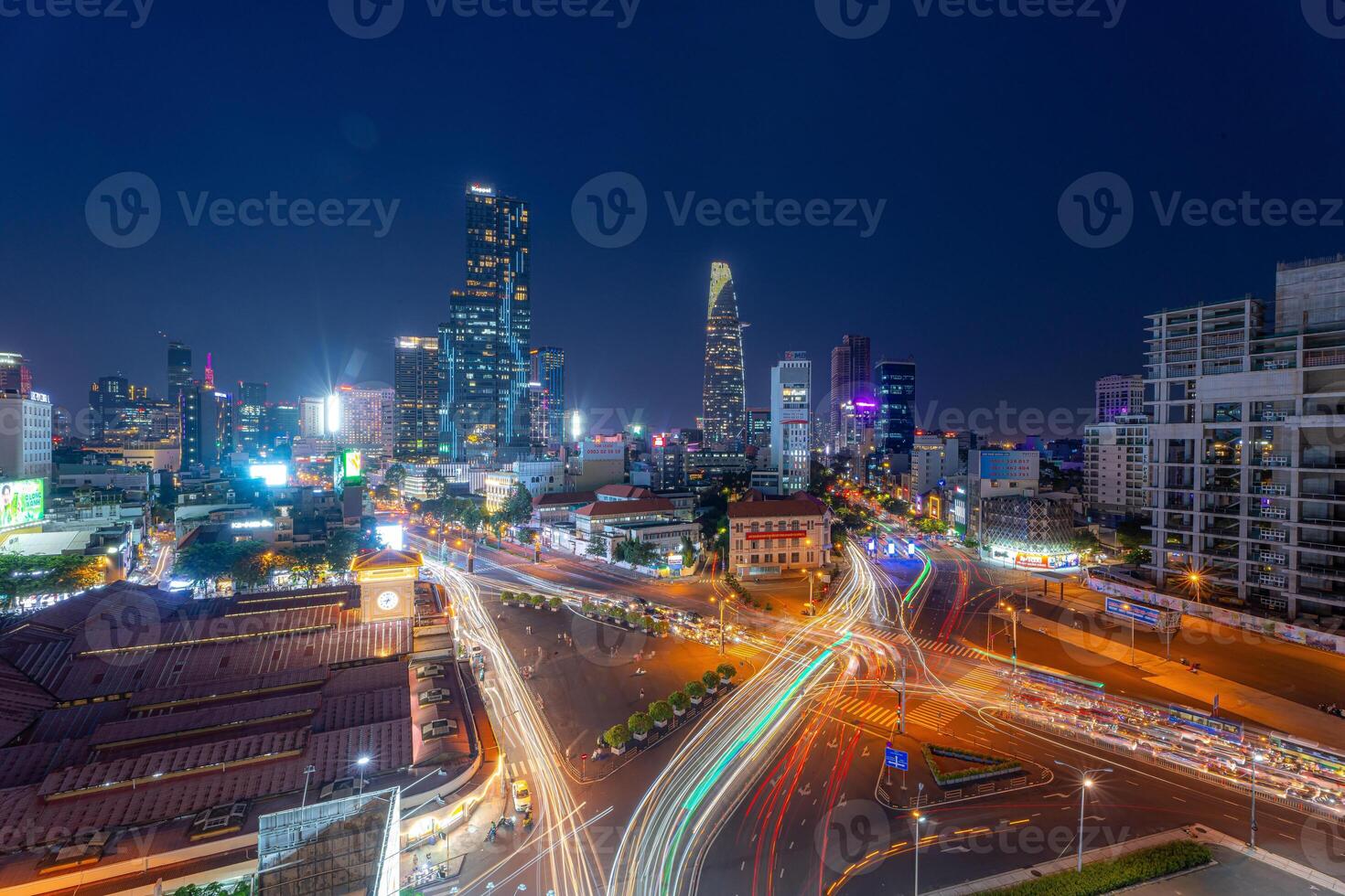 Night view of busy traffic in crowded intersection near Ben Thanh market in Ho Chi Minh city. Ben Thanh market is the symbol of Saigon, Vietnam photo