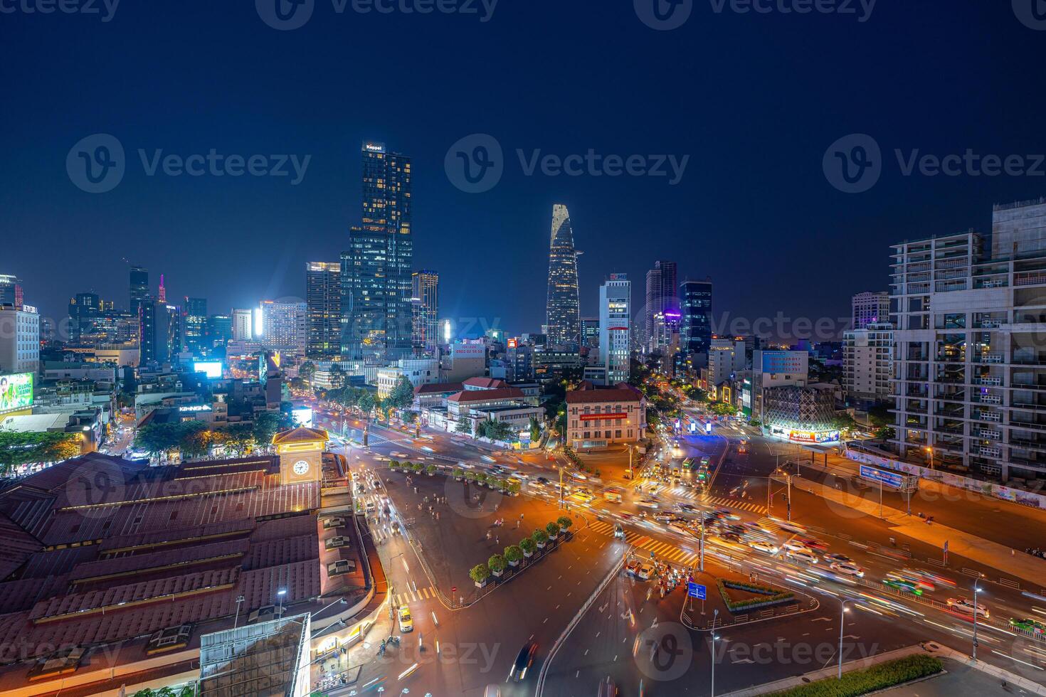 Night view of busy traffic in crowded intersection near Ben Thanh market in Ho Chi Minh city. Ben Thanh market is the symbol of Saigon, Vietnam photo