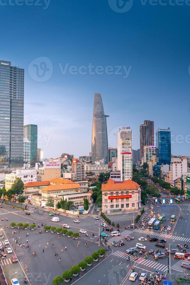 Night view of busy traffic in crowded intersection near Ben Thanh market in Ho Chi Minh city. Ben Thanh market is the symbol of Saigon, Vietnam photo
