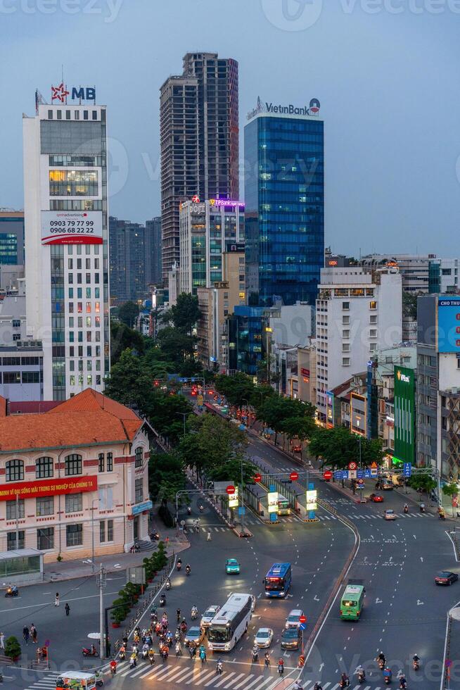 Night view of busy traffic in crowded intersection near Ben Thanh market in Ho Chi Minh city. Ben Thanh market is the symbol of Saigon, Vietnam photo
