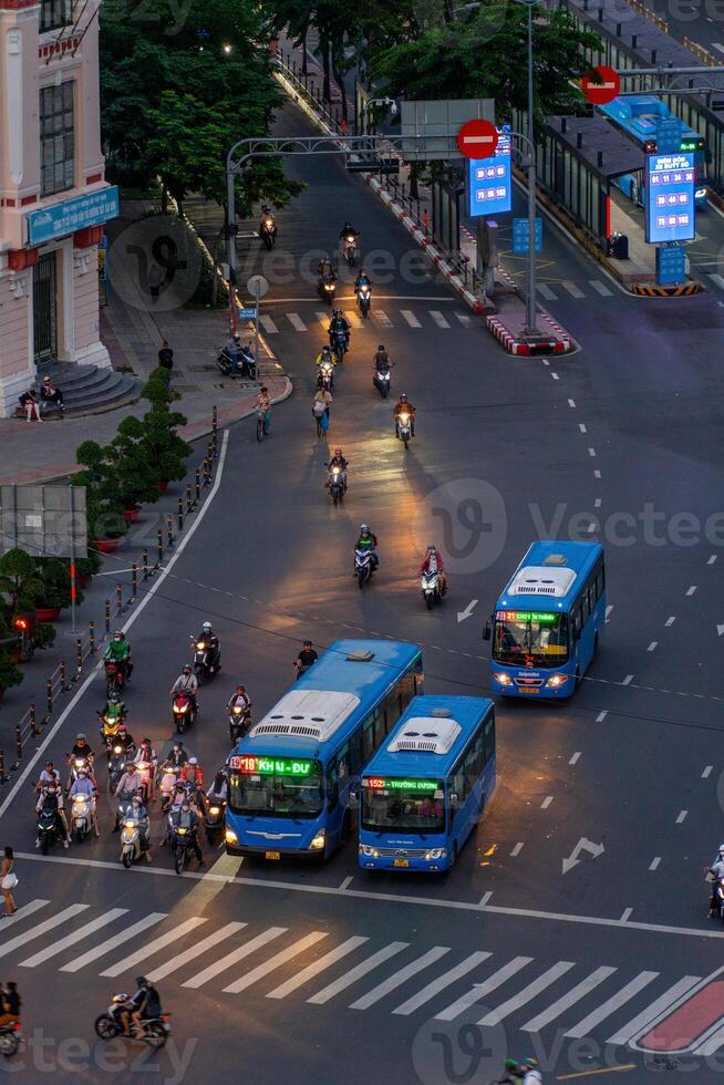Night view of busy traffic in crowded intersection near Ben Thanh market in Ho Chi Minh city. Ben Thanh market is the symbol of Saigon, Vietnam photo