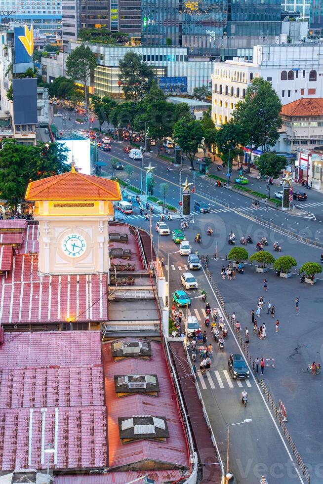Night view of busy traffic in crowded intersection near Ben Thanh market in Ho Chi Minh city. Ben Thanh market is the symbol of Saigon, Vietnam photo