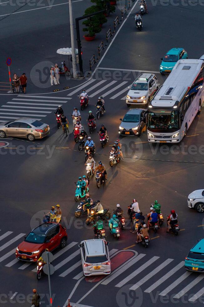 Night view of busy traffic in crowded intersection near Ben Thanh market in Ho Chi Minh city. Ben Thanh market is the symbol of Saigon, Vietnam photo