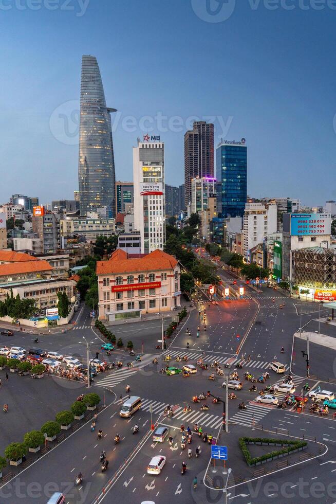 Night view of busy traffic in crowded intersection near Ben Thanh market in Ho Chi Minh city. Ben Thanh market is the symbol of Saigon, Vietnam photo