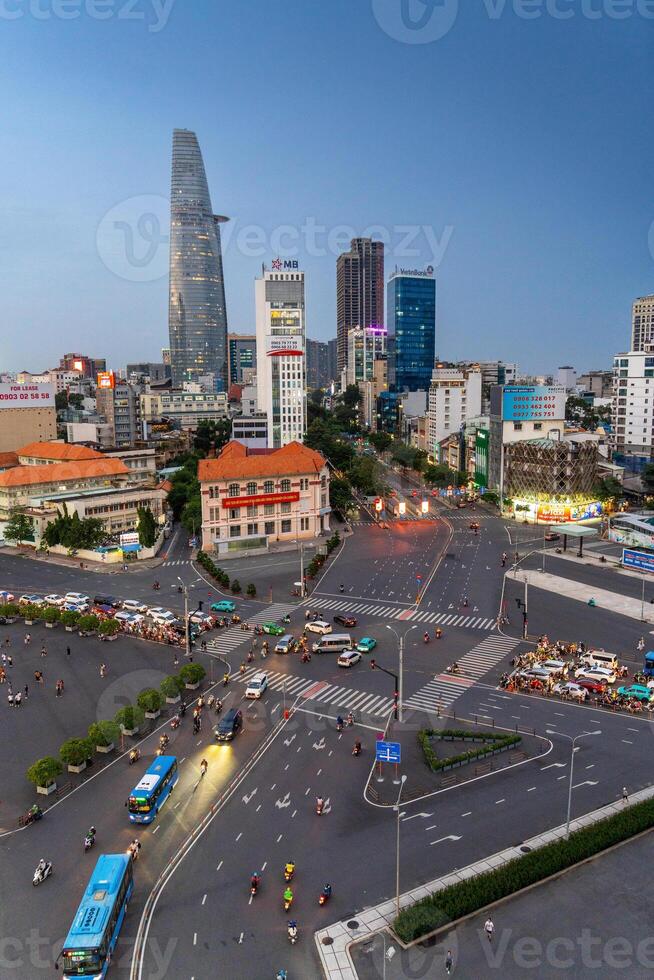 Night view of busy traffic in crowded intersection near Ben Thanh market in Ho Chi Minh city. Ben Thanh market is the symbol of Saigon, Vietnam photo