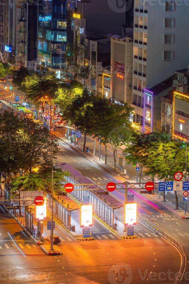 Night view of busy traffic in crowded intersection near Ben Thanh market in Ho Chi Minh city. Ben Thanh market is the symbol of Saigon, Vietnam photo