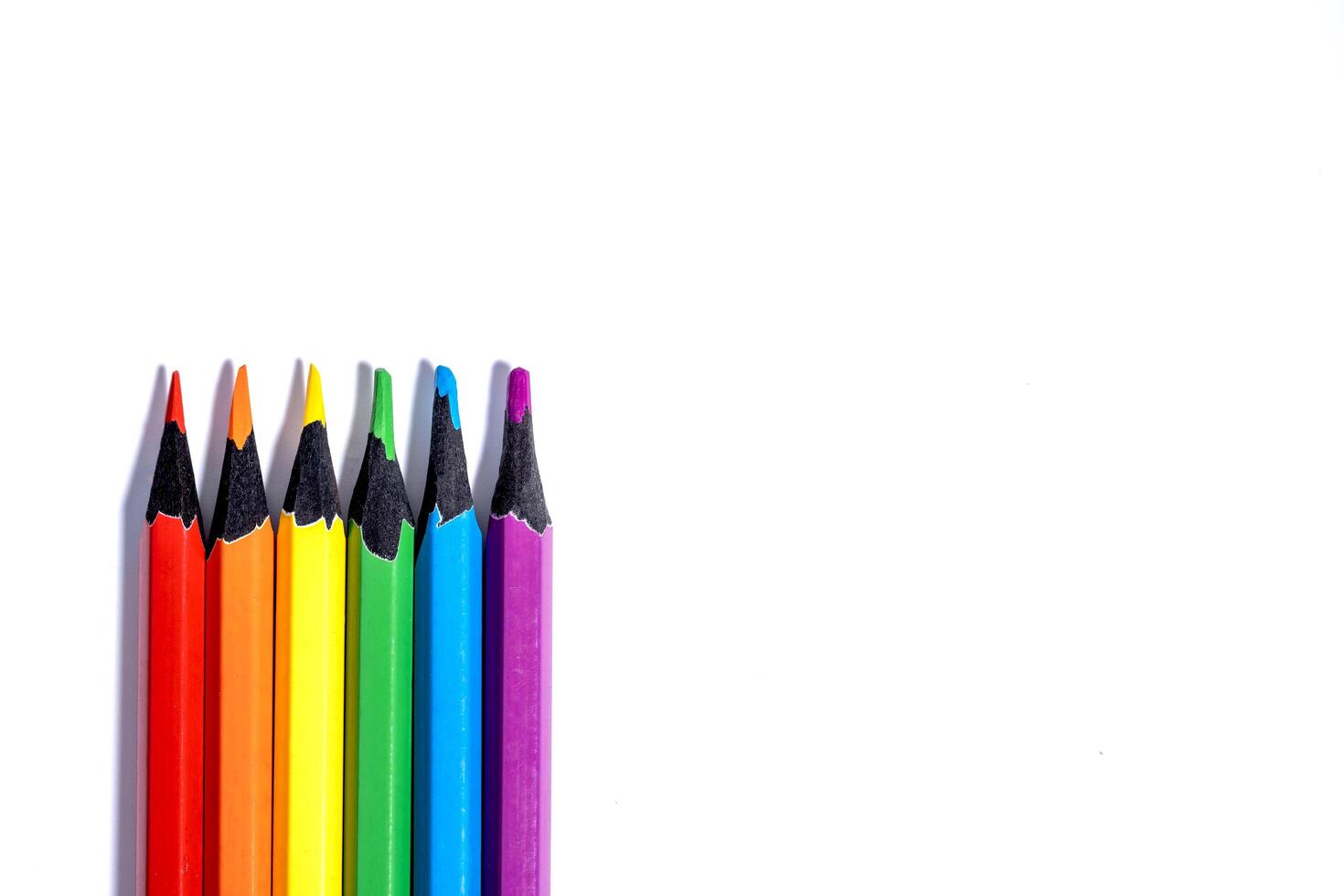 Set of colored pencils in the colors of the LGBT flag on a white background with copy space photo