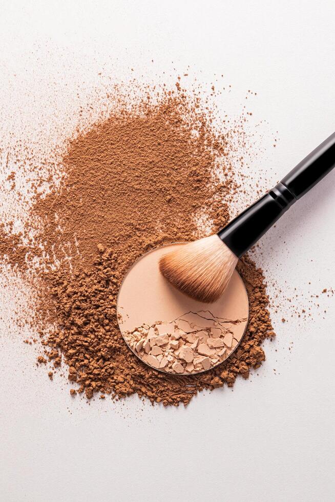 loose round block powder and makeup brush, applying powder on face on white background. Concept of cosmetics , makeup. Top view. photo