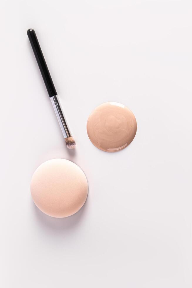 Cosmetic Round Porous Sponge, Foundation Brush, Round Large Drop, Swatch, Foundation Spot on White Vertical Background. cosmetic background. photo