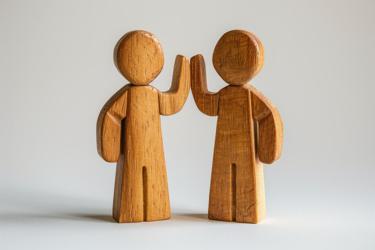 Wooden Figures High-Fiving - Symbol of Teamwork, Unity, and Collaboration in Minimalist Style photo