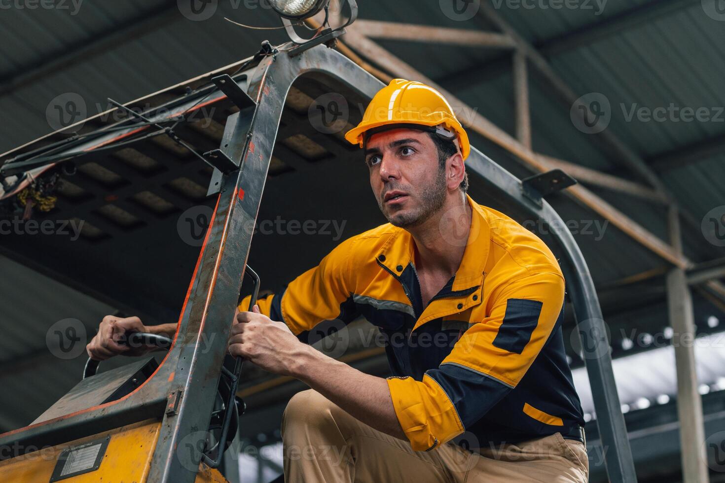 Caucasian engineer using a laptop in a factory. man working in plastics factory. photo