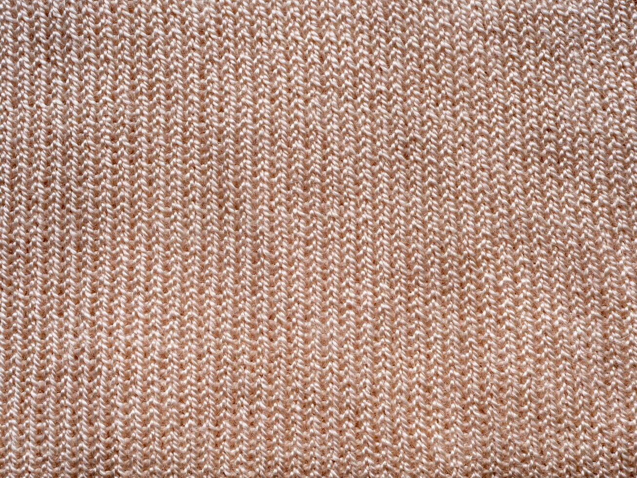 top view beige knitted wool fabric closeup texture background photo