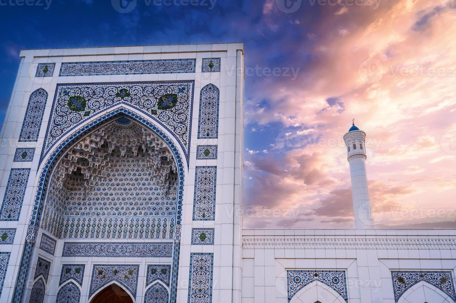 marble wall decorated uzbek ornaments and white minaret of new Islamic Minor Mosque in Tashkent in Uzbekistan on background of beautiful sky photo